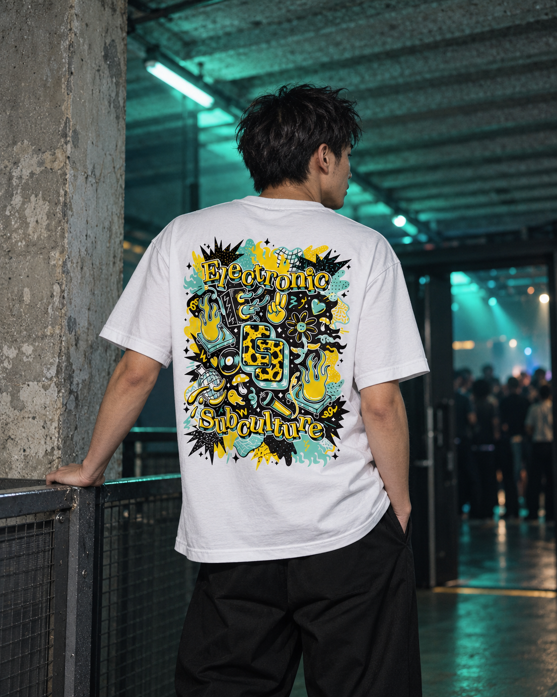 Yellow and mint BXL T-shirt worn in a concrete corridor
